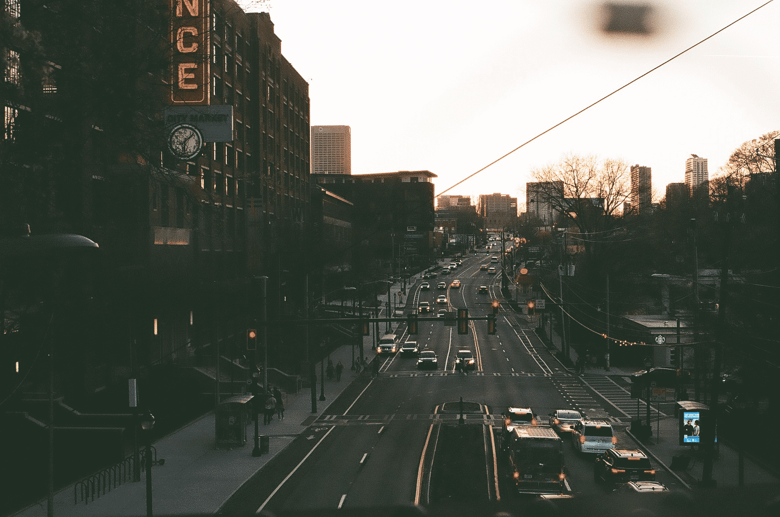 City street at night with cars and neon signs