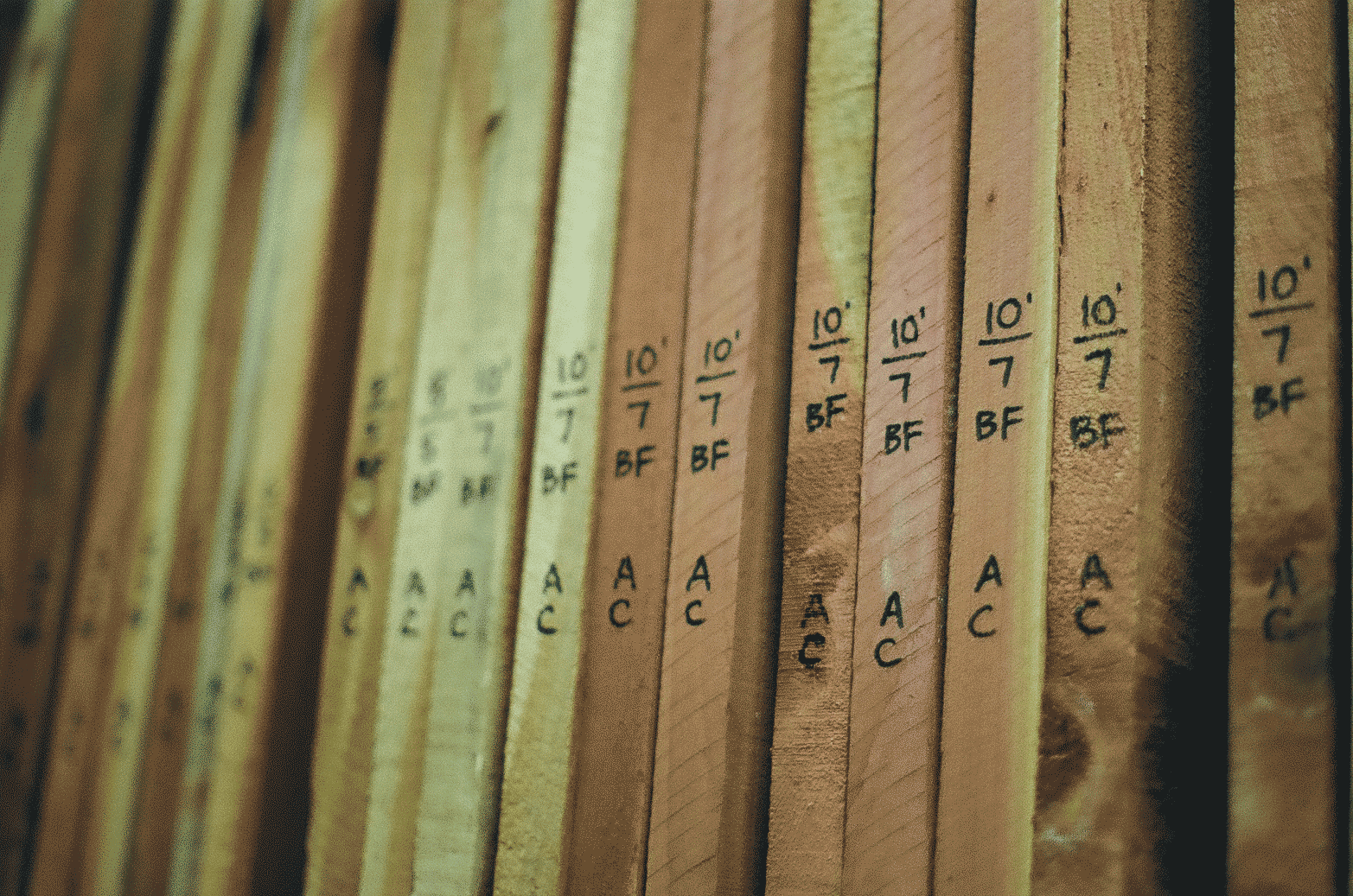 Slats of lumber with measurements written on them